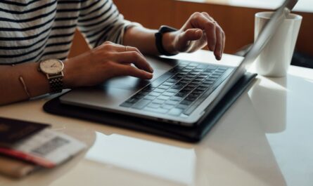 Person using a laptop to prepare an official banking service complaint